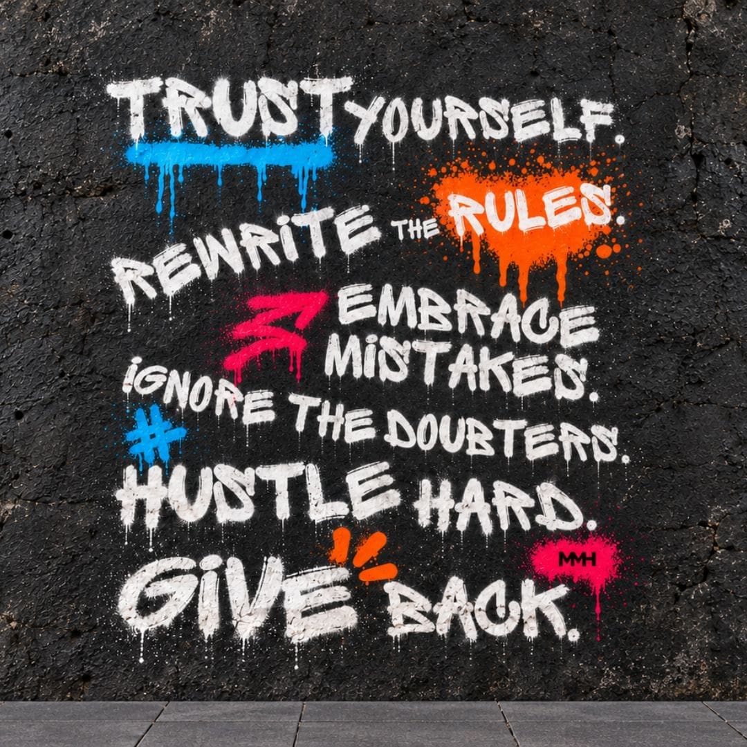 Colourful motivational graffiti slogan painted on a cracked black wall